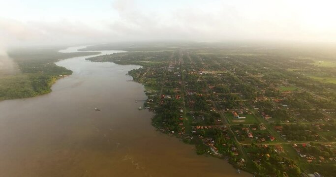 Aerial view with cluds on the foreground of the city of Soure located on Marajó Island, in the Amazon rainforest, Brazil