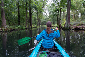 female kayaker enjoys paddling through the channels and canals o the Spreewald region in Germany