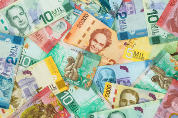 Money from Costa Rica. All denominations, paper banknotes, scattered on the table