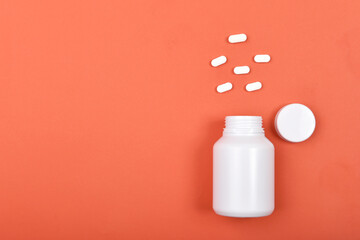 Medicine pills and drug bottle on colorful background with copyspace, Minimal healthcare concept.