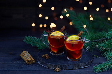 Christmas hot mulled wine with cinnamon cardamom and anise on a wooden background