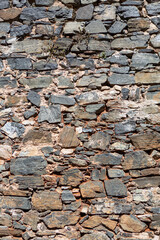 View of a rustic and old schist exterior wall, architectural textures, detailed wall masonry schist