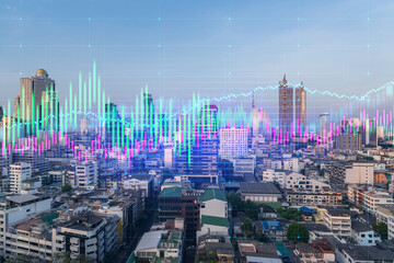 Sunset cityscape of big city view background with forex graph. Success and finance concept. Multiexposure