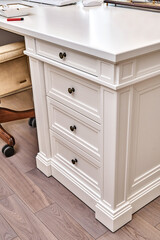 White wooden classic desk with drawers in home office