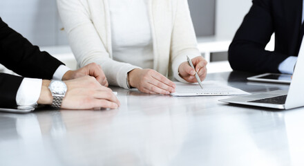 Business people discussing contract working together at meeting in modern office. Unknown...