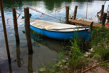 Obraz premium rustic craft marina on a swampy river where small boats moor in the green jungle
