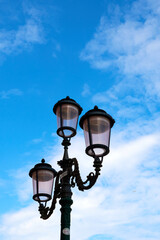 Fototapeta na wymiar particular street lamp on blue sky