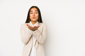 Young woman isolated on a white background folding lips and holding palms to send air kiss.