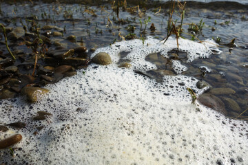 Stack of foam on the shore of Lake accumulated torrential waves