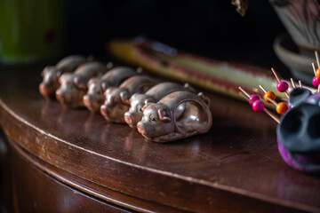 Porcelain Pigs in a Row