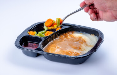 Turkey and mashed potatoes TV dinner with a fork of vegetables