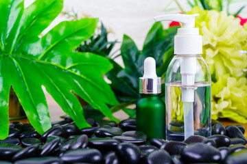 Cosmetic glass bottle for essential oils on black stone