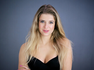 Naklejka premium Portrait of nice pretty blonde lady isolated over grey background. Beauty and lifestyle concepts