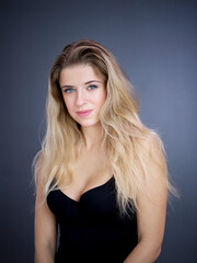Fototapeta premium Portrait of nice pretty blonde lady isolated over grey background. Beauty and lifestyle concepts