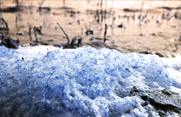 Stack of foam on the shore of Lake accumulated torrential waves