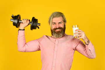Fototapeta na wymiar Source of calcium. Bearded man drink milk. Exercise in gym. Milk good nutrients. Amount of fat. Vitamins for muscles. Sportsman hold dumbbell and glass of milk. Protein diet. Protein cocktail