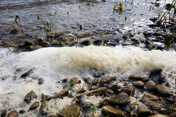 Stack of foam on the shore of Lake accumulated torrential waves