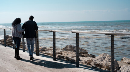 Couple holding hands at the promenade