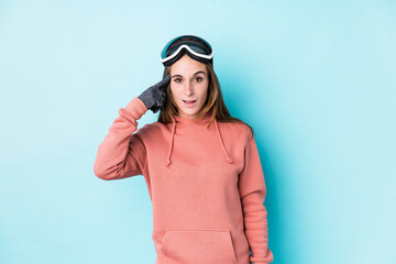 Young skier woman isolated showing a disappointment gesture with forefinger.