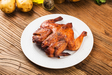 Fresh roast chicken on a wooden board background