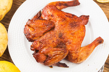 Fresh roast chicken on a wooden board background
