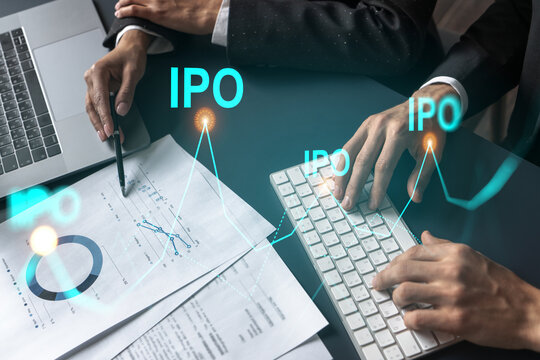 Two business people working together on white paper to release and present IPO project to investors. Initial primary offering hologram. Double exposure.