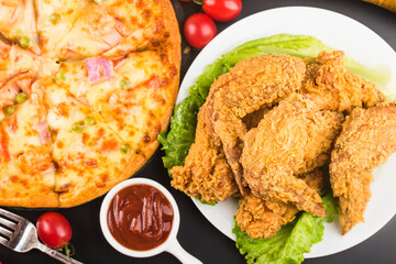 Fried chicken wings on wooden table.