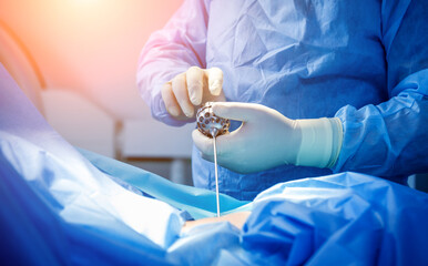 Surgeon performs endoscopic microdiscectomy of herniated intervertebral disc. - obrazy, fototapety, plakaty