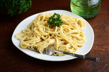 spaghetti with white cream sauce and a fork