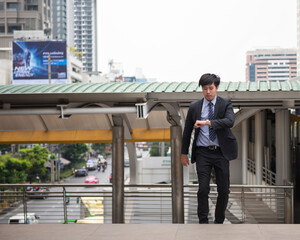 Late businessman check time and run in city
