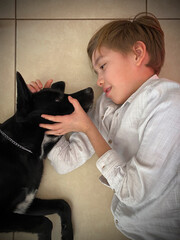 child caresses and plays with his dog, cute attitude