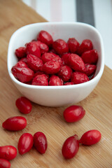 red dogwood berries in a white bowl