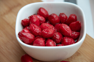 red dogwood berries in a white bowl