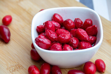 red dogwood berries in a white bowl