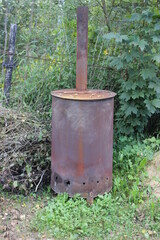 Round iron stove outside. Russia.