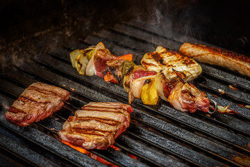 kebab, chicken breast, steak and sausage are grilled