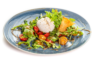 Mozzarella, cherry tomato salad and arugula on a blue plate