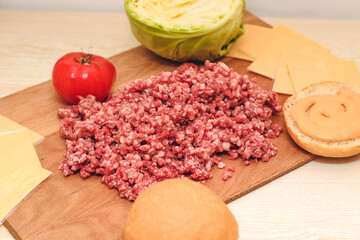 Fresh minced meat for making a burger at home. Ingredients for a homemade cheeseburger.