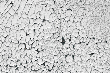 Old cracked paint texture. White paint on black surface.