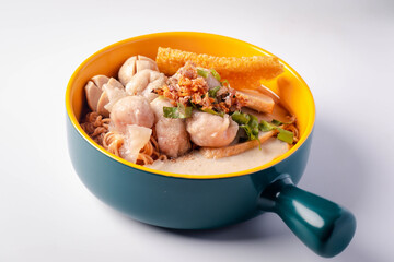 Instant noodles with fish kiew, pork balls and wonton plates. Thai food on a white background.