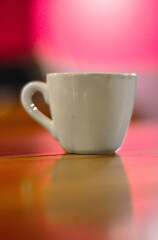 Close up White coffee cup on wooden table in cafe with blur background. Modern cafe concept