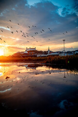 view of Bratislava castle on late afternoon in water pool with the ricochet and beautiful sunset on...