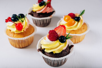 chocolate cupcakes with cream and fresh berries