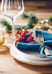 Festive table setting with winter decor. The concept of Thanksgiving or Christmas family dinner.