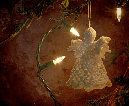 Antique Christmas ornament hanging from the tree at night, grunge textured.