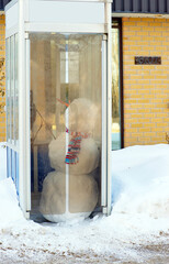 Snowman in a phone booth.