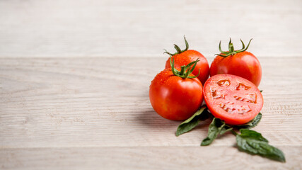 Tomatoes on white kitchen and tomato juice with green tomato leaves. Home grown tomatoes 