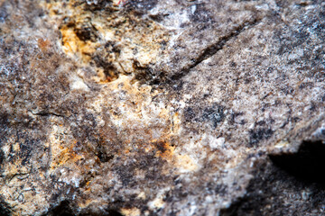 Stone surface texture at high magnification with numerous chips and small details