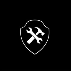 Hammer and wrench with shield icon isolated on dark background