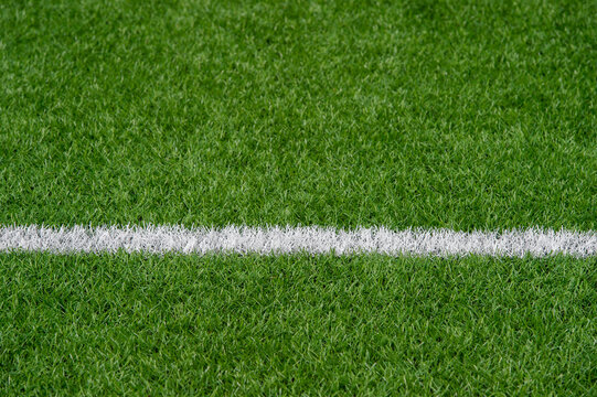 Green Synthetic Grass Sports Field With White Line Shot From Above. Soccer, Rugby, Football, Baseball Sport Concept